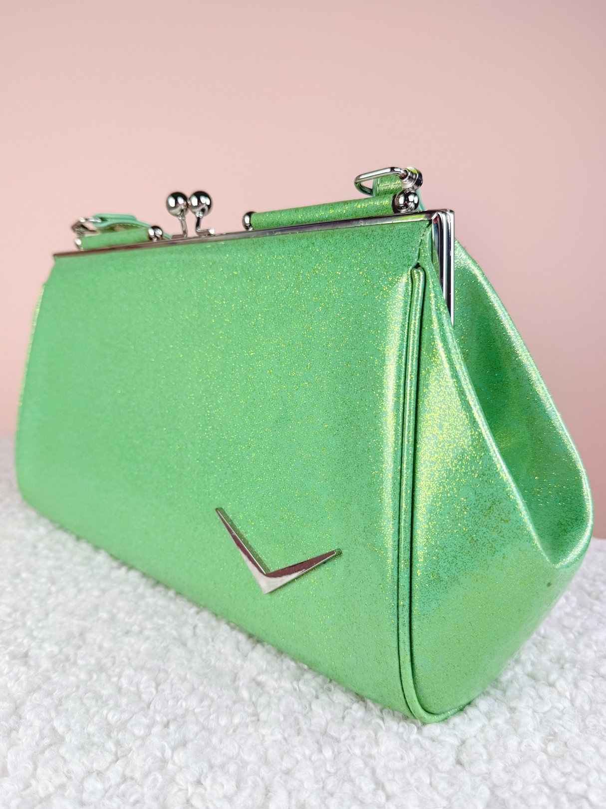 Sparkling mint green 1950s handbag with a metallic clasp and a triangular decorative element on the side.