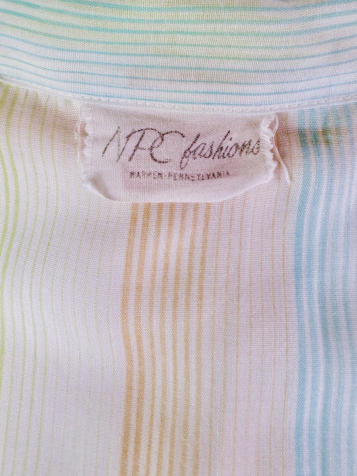 Citrus Dress featuring a pastel striped pattern with colors including orange, green, and blue, designed for women in the 1950s.