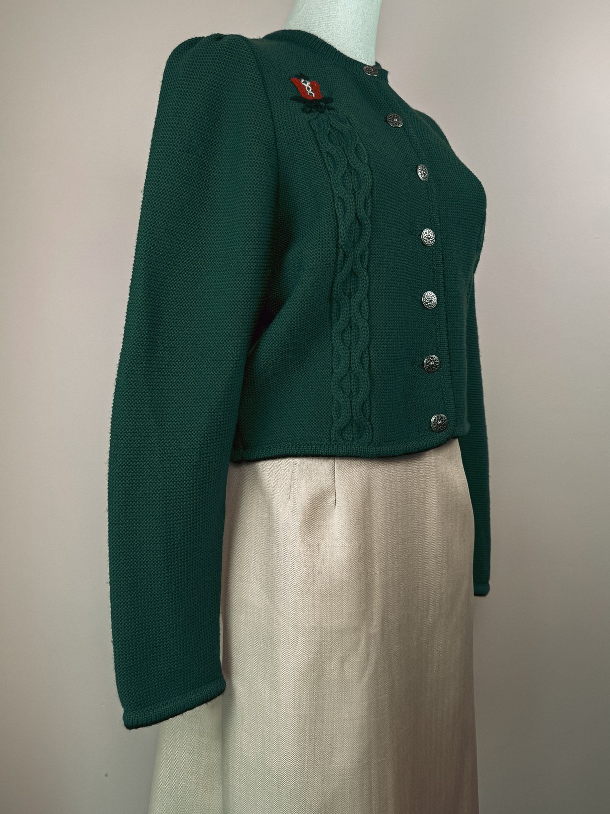 Green M & G Tulip Embroidered Cardigan from the 1980s, featuring a textured knit and silver buttons, displayed on a mannequin with a neutral-colored skirt.