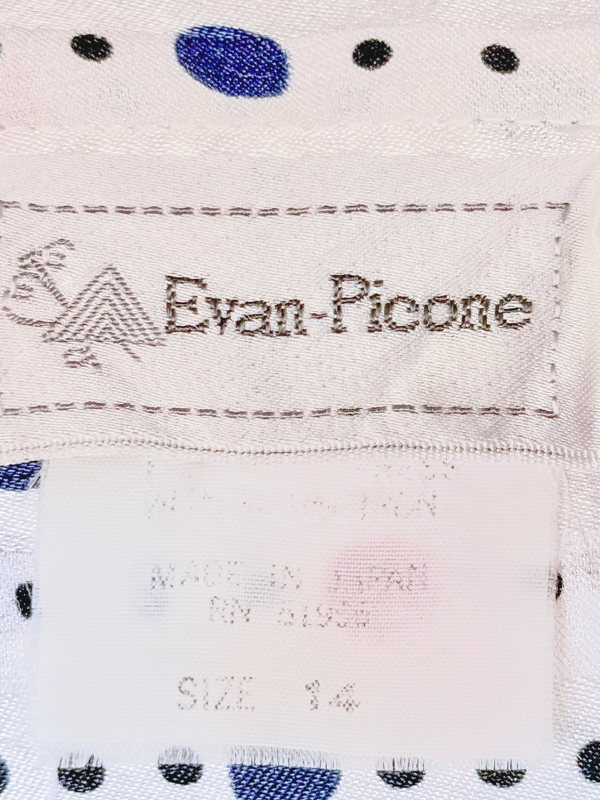 Evan-Picone label on a blouse featuring red fabric with blue polka dots, size 14.