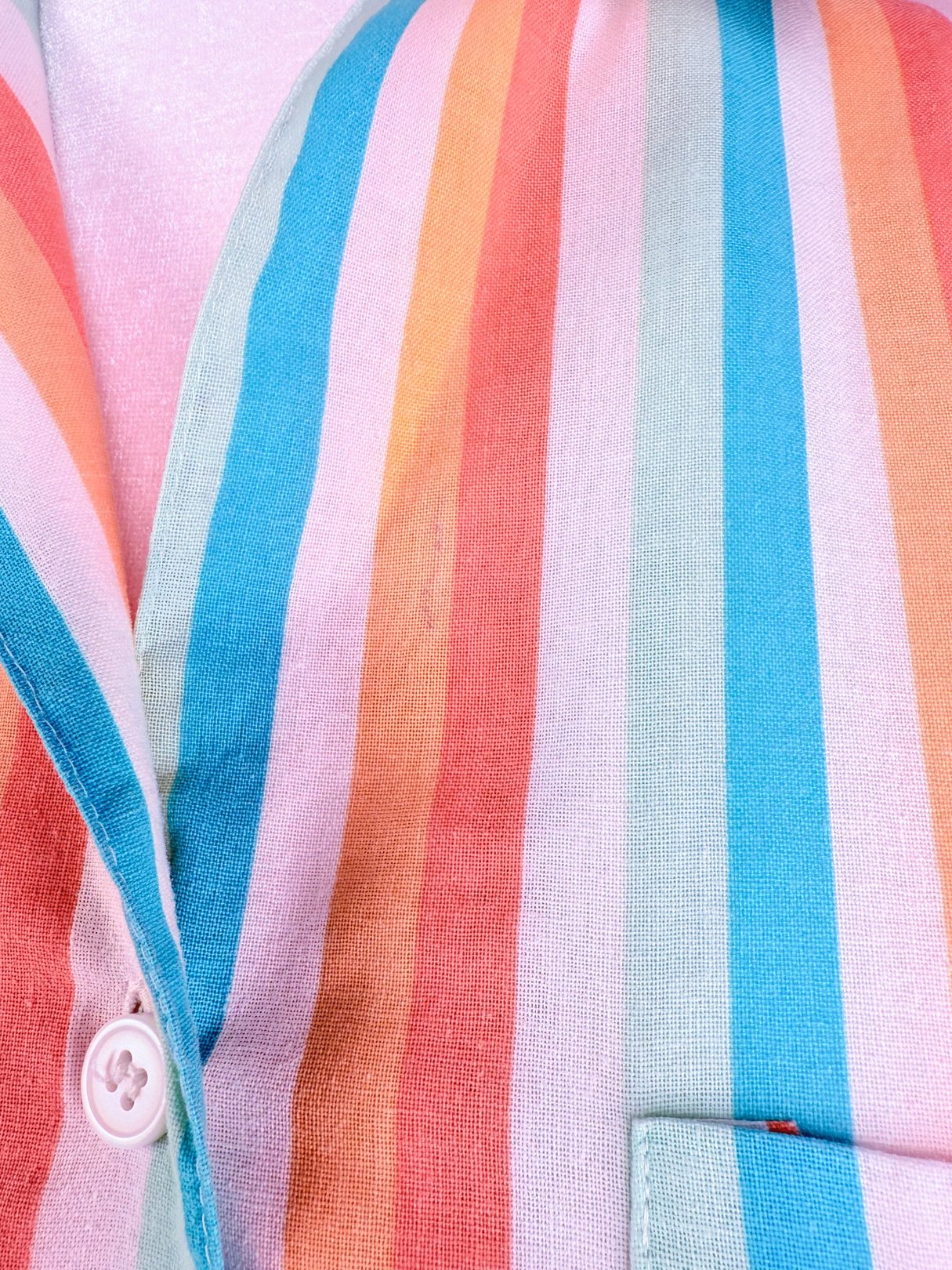Colorful striped fabric featuring blue, pink, and orange hues typical of a women's 1980s romper.