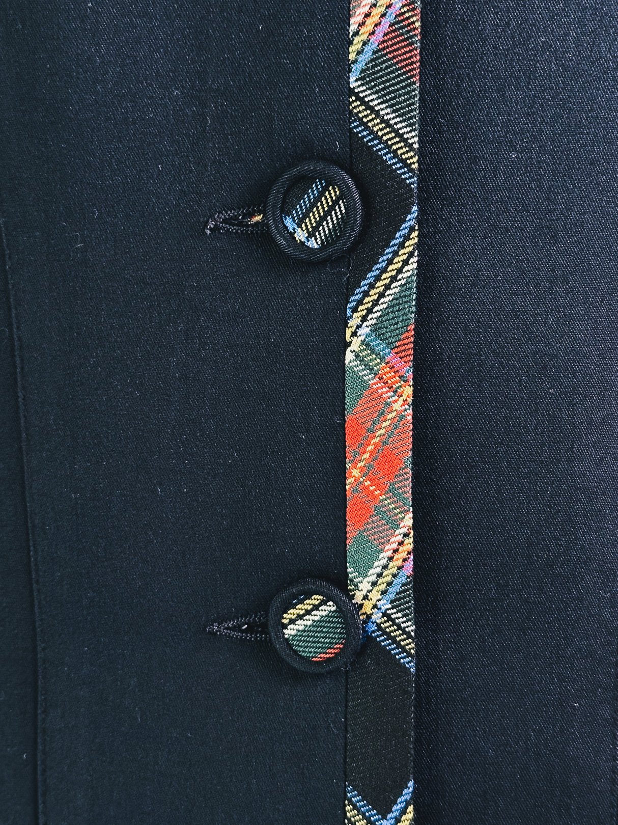 Black women's 1990s plaid suit jacket featuring a tartan trim and double buttons.