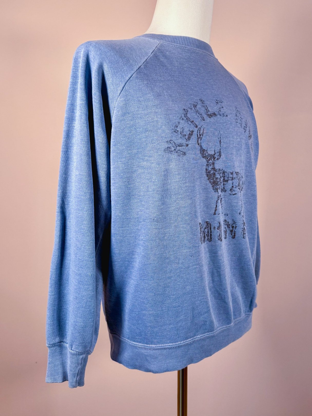 1970s men's blue sweatshirt featuring a graphic of a deer and the text "Kettle River Minn.