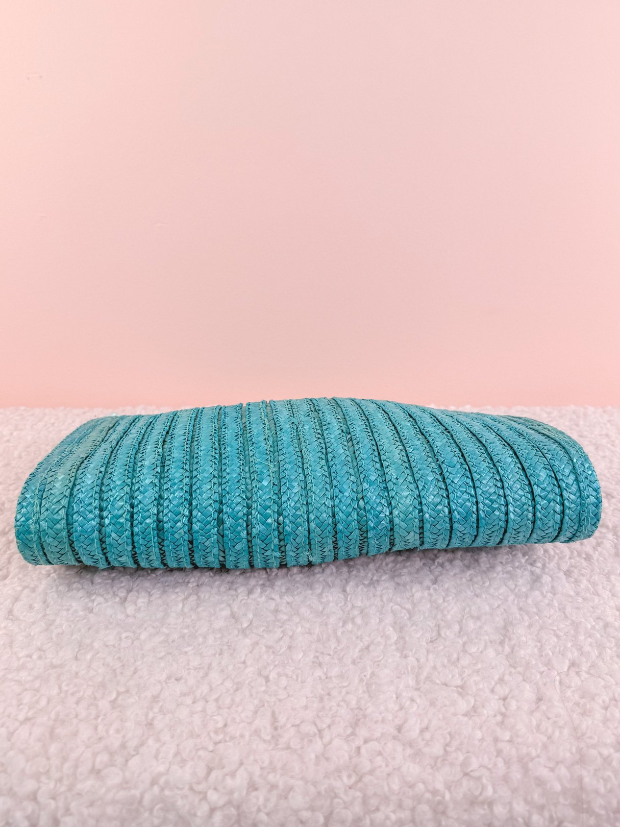 Teal blue 1970s shoulder bag made of textured fabric, featuring a flat, rectangular shape.