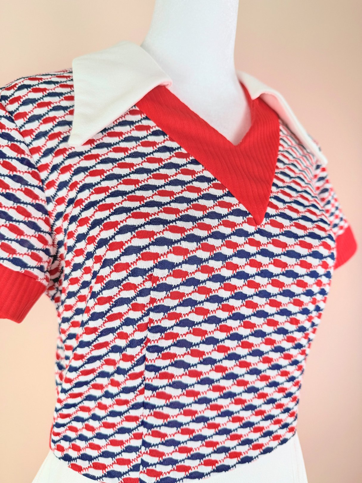 Red and white 1970s women’s Bottle Rocket Dress featuring a patterned top with a v-neck and short sleeves.