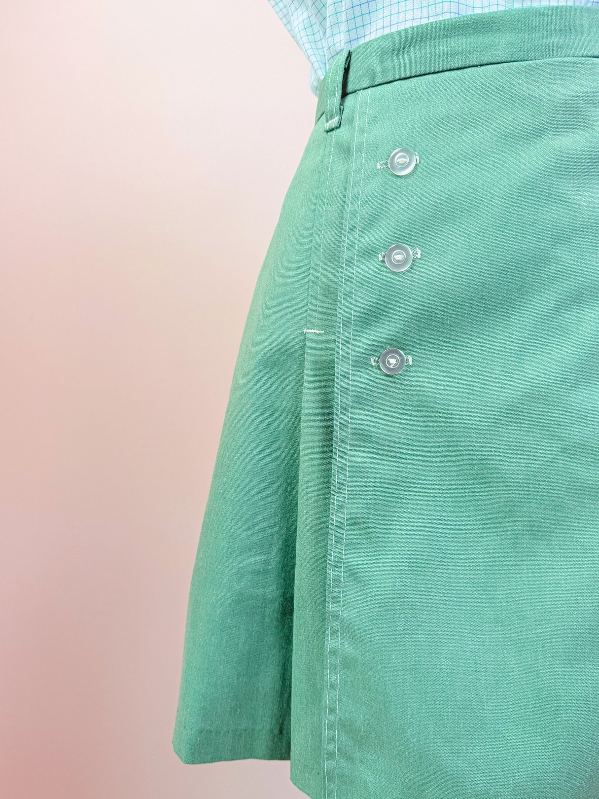 The Gator Sailor Skort is a women's 1970s green skirt featuring three decorative buttons on the side.