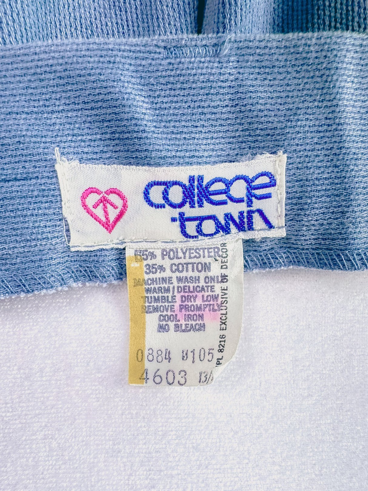 Light blue 1970s women's pants with a woven fabric label indicating a blend of polyester and cotton.