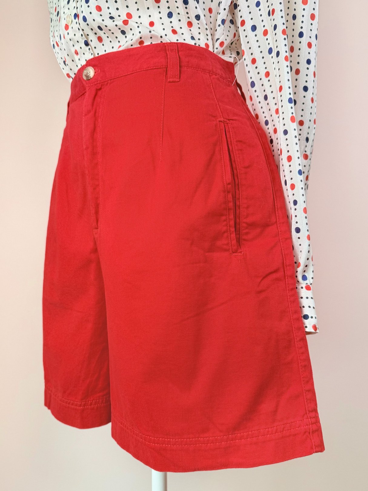Women’s red shorts from the 1980s featuring a high waist and side pockets.