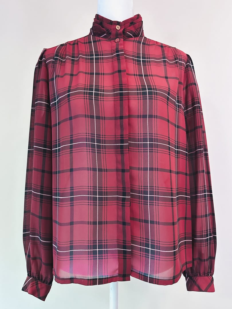 Maroon plaid blouse with a high collar and button-up front, featuring long sleeves and a relaxed fit, reflecting 1960s style.