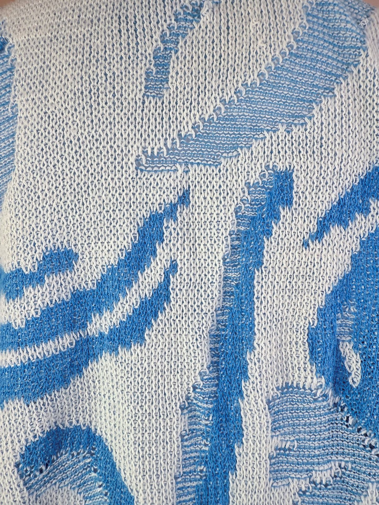 Yasaki Knit Polo Sweater in white with blue abstract patterns, showcasing a knitted texture typical of 1980s women's fashion.