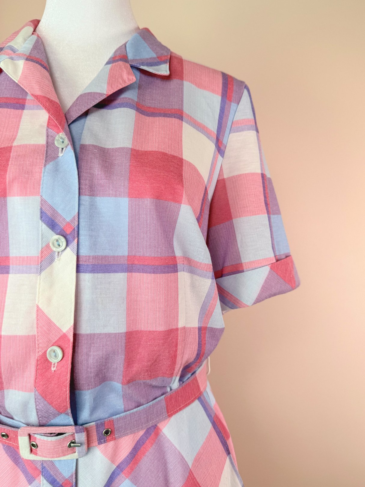 Purple Picnic Plaid Dress featuring a button-down front, short sleeves, and a belted waist with a pink and purple plaid pattern.