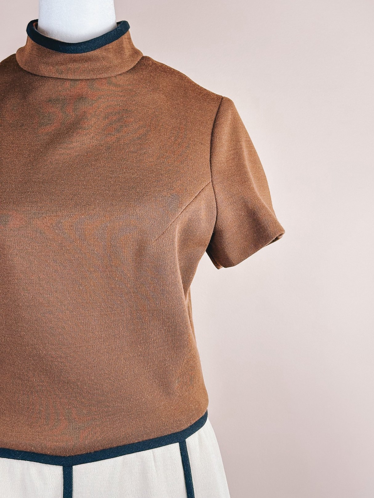 1960s British Mod Squared Dress for women featuring a brown top with short sleeves and a high neckline.