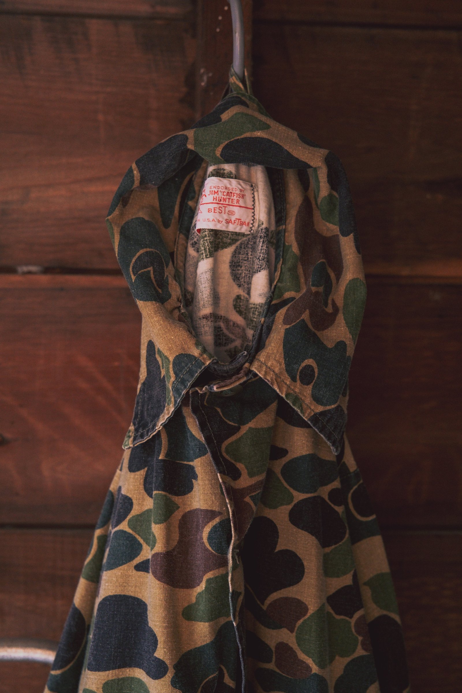 Camo-patterned fabric featuring a collar with a visible label.