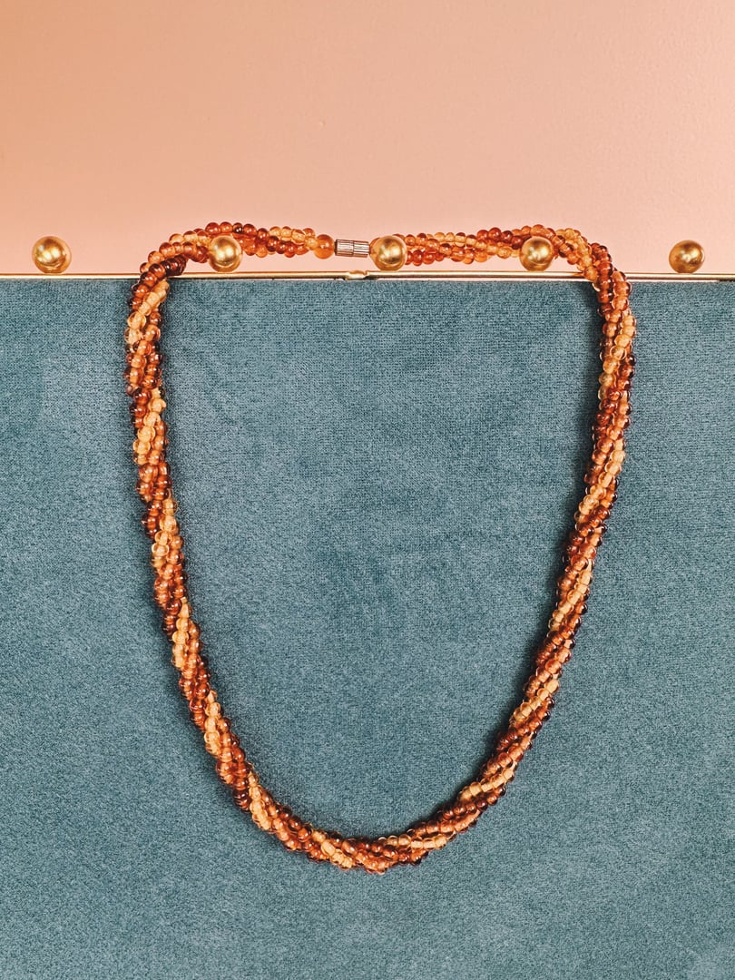 Amber Harvest Beaded Necklace featuring twisted strands of amber-colored beads, designed for women and inspired by 1970s style.