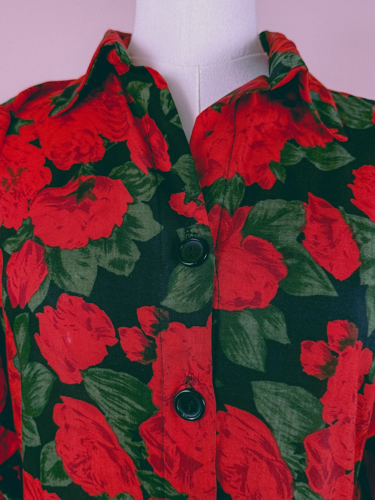 Red floral dress with a button-up collar, featuring a 1990s design with black and green accents.