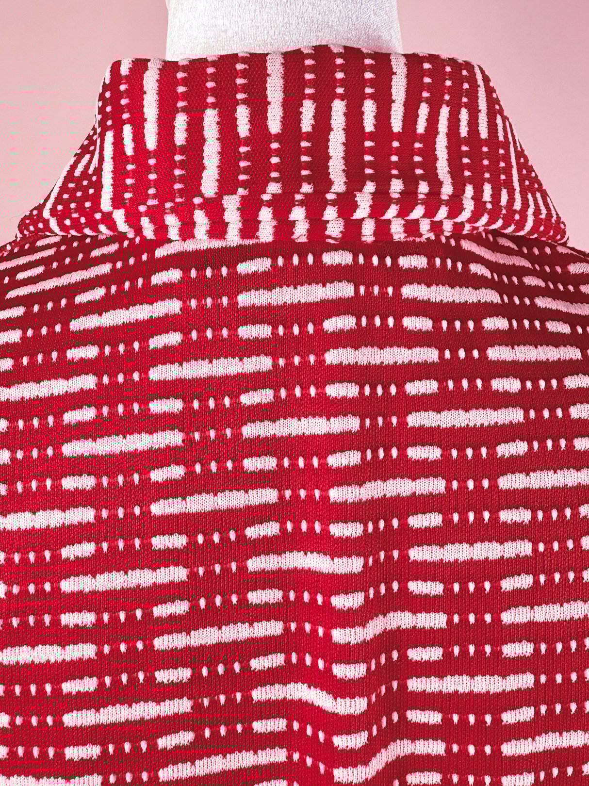 Red 1970s women's knit dress featuring a textured striped pattern and a collared neckline.