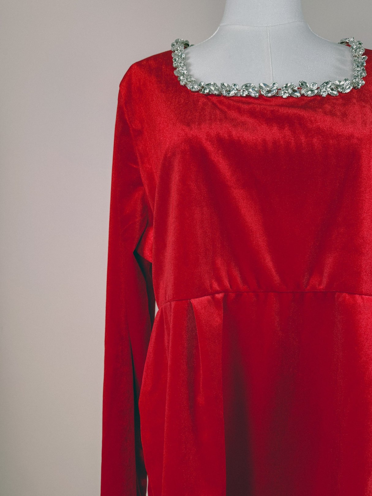 Red velvet dress for women featuring a square neckline embellished with a decorative floral trim, designed in a 1970s style.