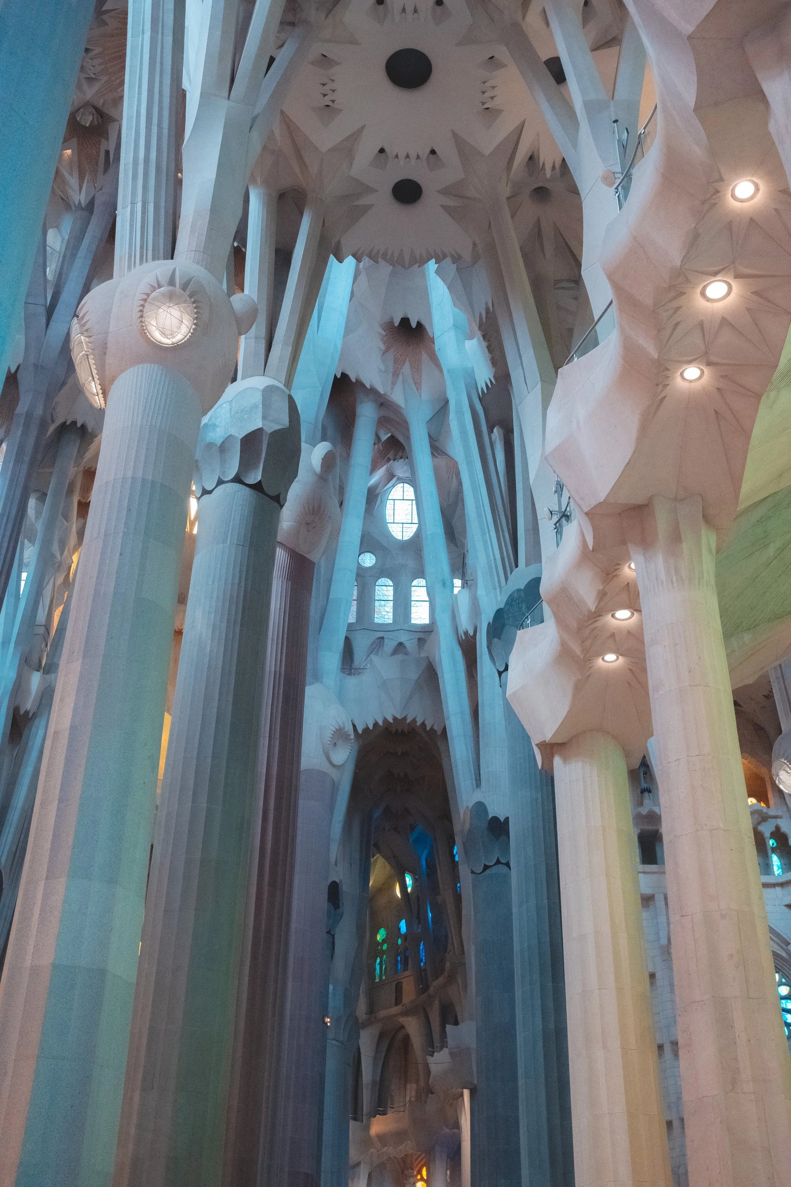 Interior view of the Basilica de la Sagrada Família showcasing its intricate columns and stained glass windows.