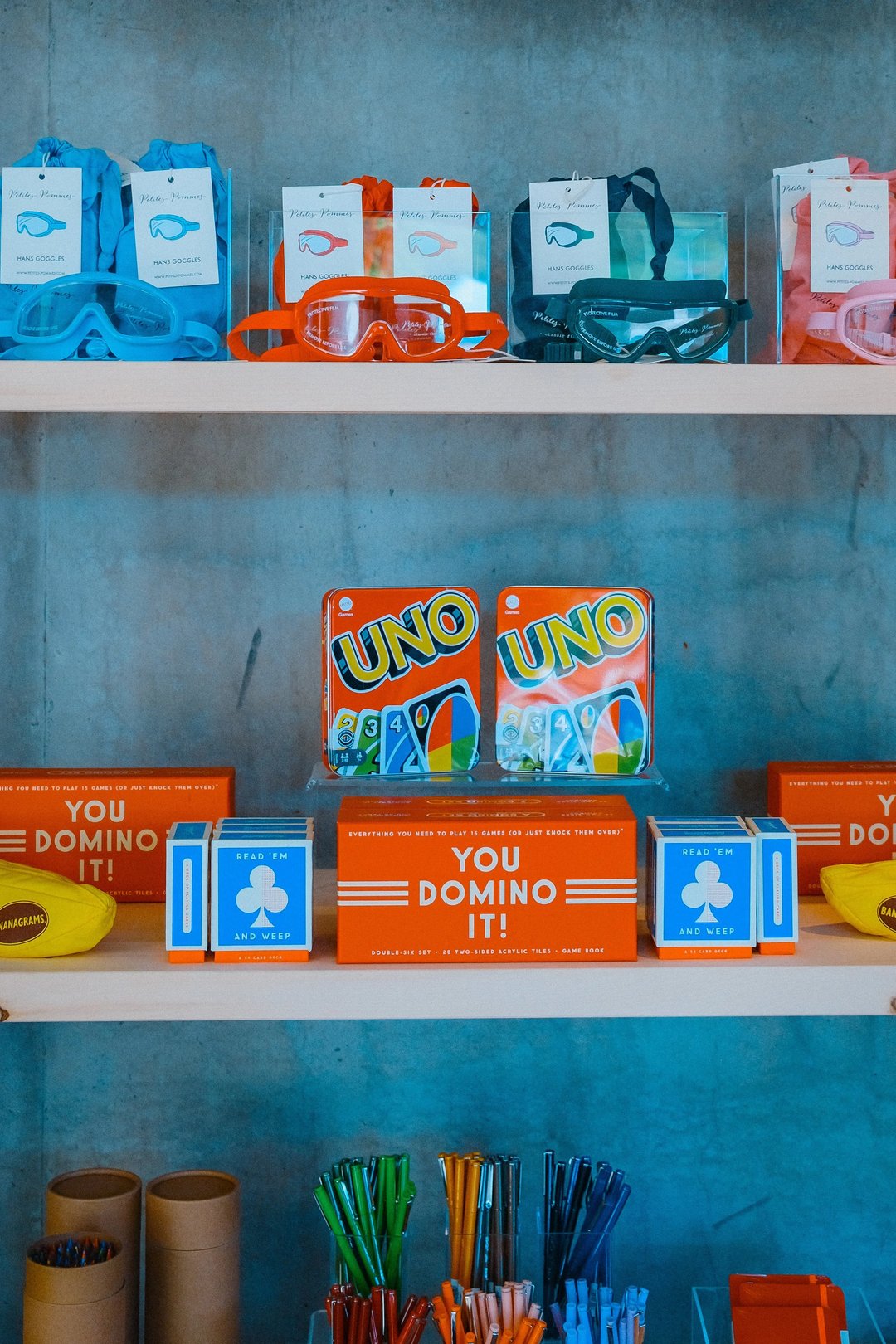 A colorful display of various snacks and candy boxes on a wooden shelf.