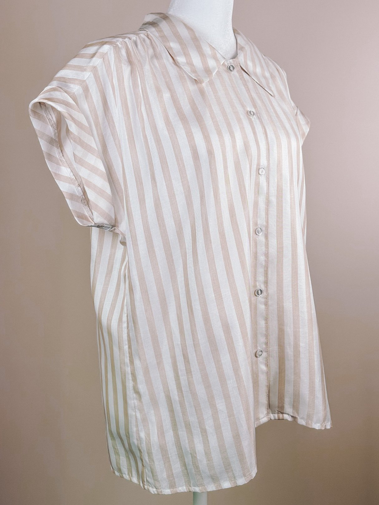 1970s white blouse with tan and blush stripes, featuring a collared neckline and short sleeves.