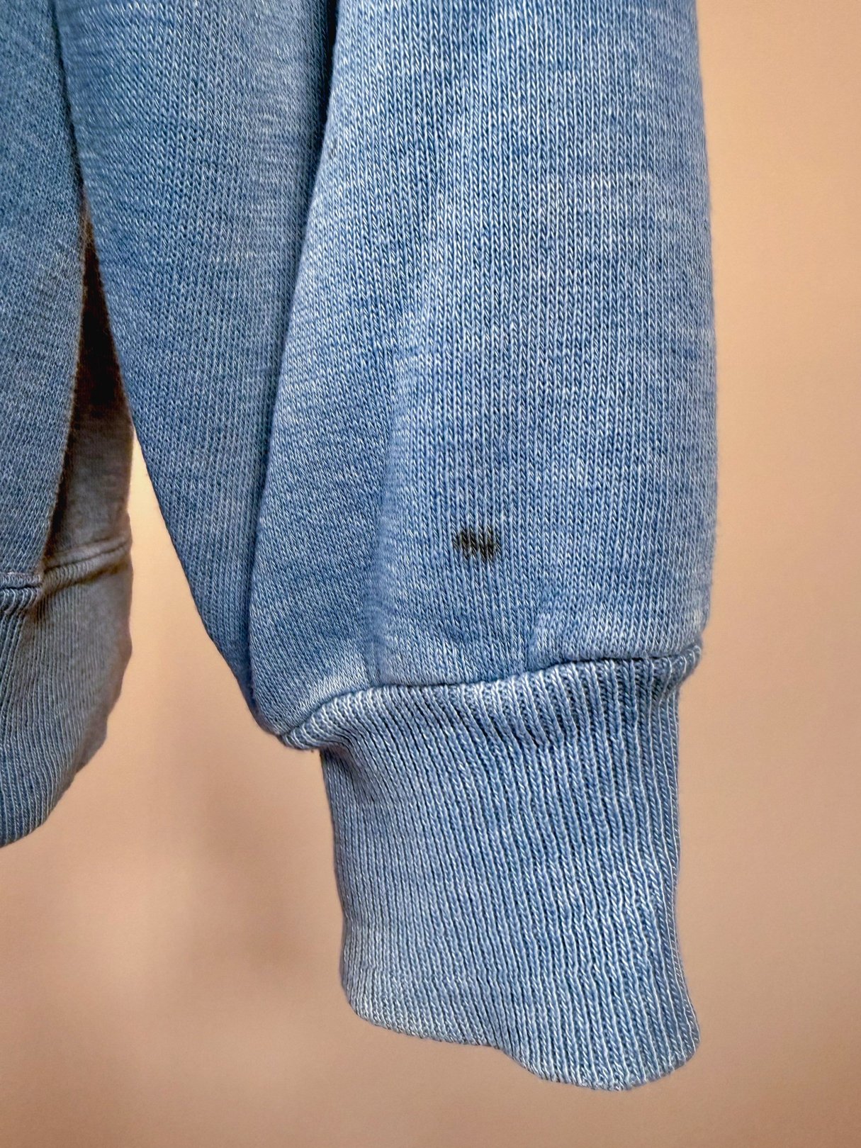 Blue vintage 1970s Kettle River Minn. sweatshirt for men featuring a worn texture and a small mark on the cuff.