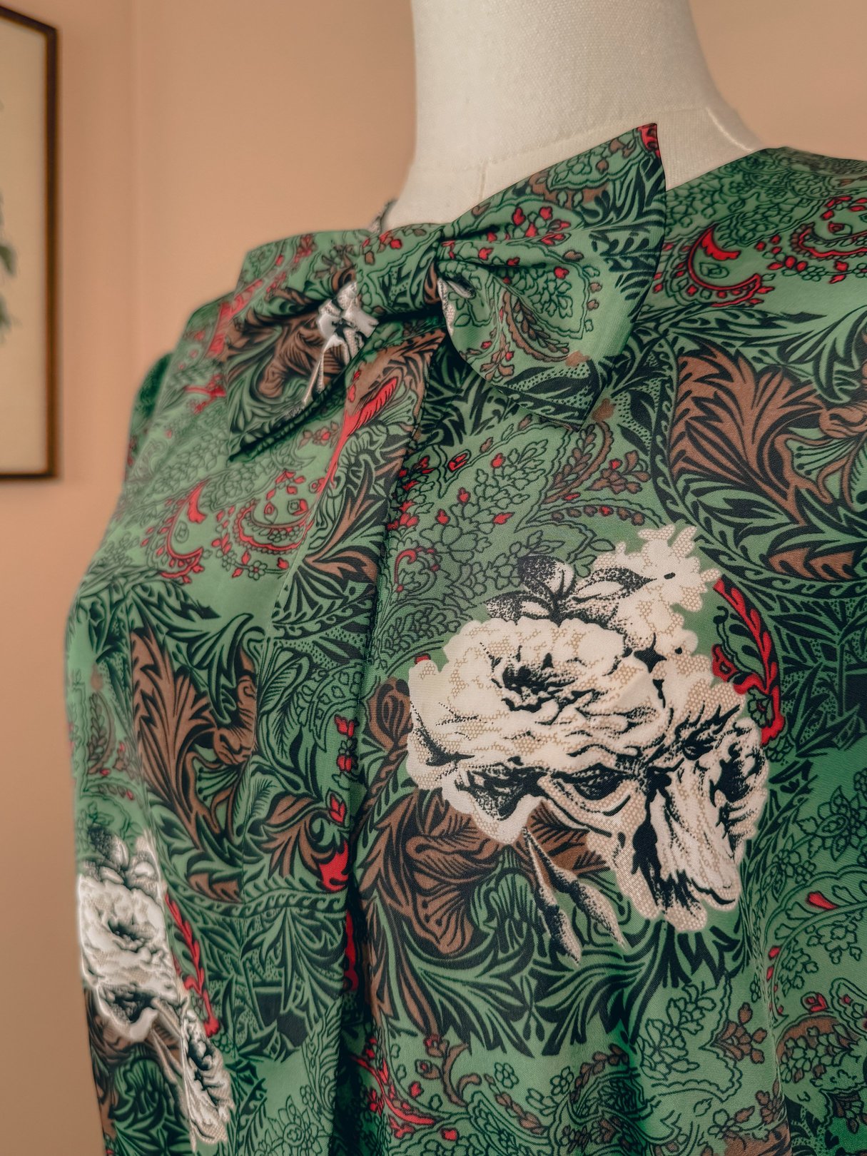Red floral bow top for women from the 1980s featuring a nature-inspired design with green and brown accents.