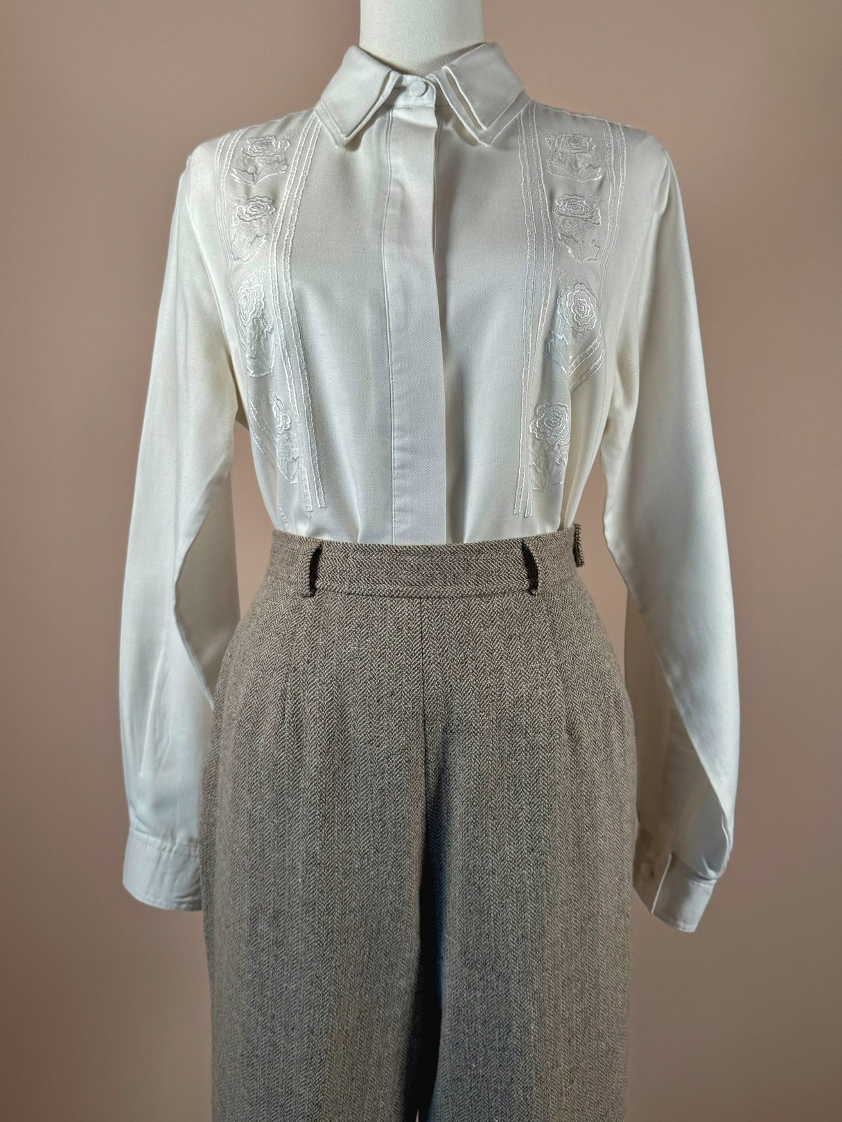 Women's 1990s tan birch tweed pants featuring a high waist and front pleats, styled with a cream blouse.