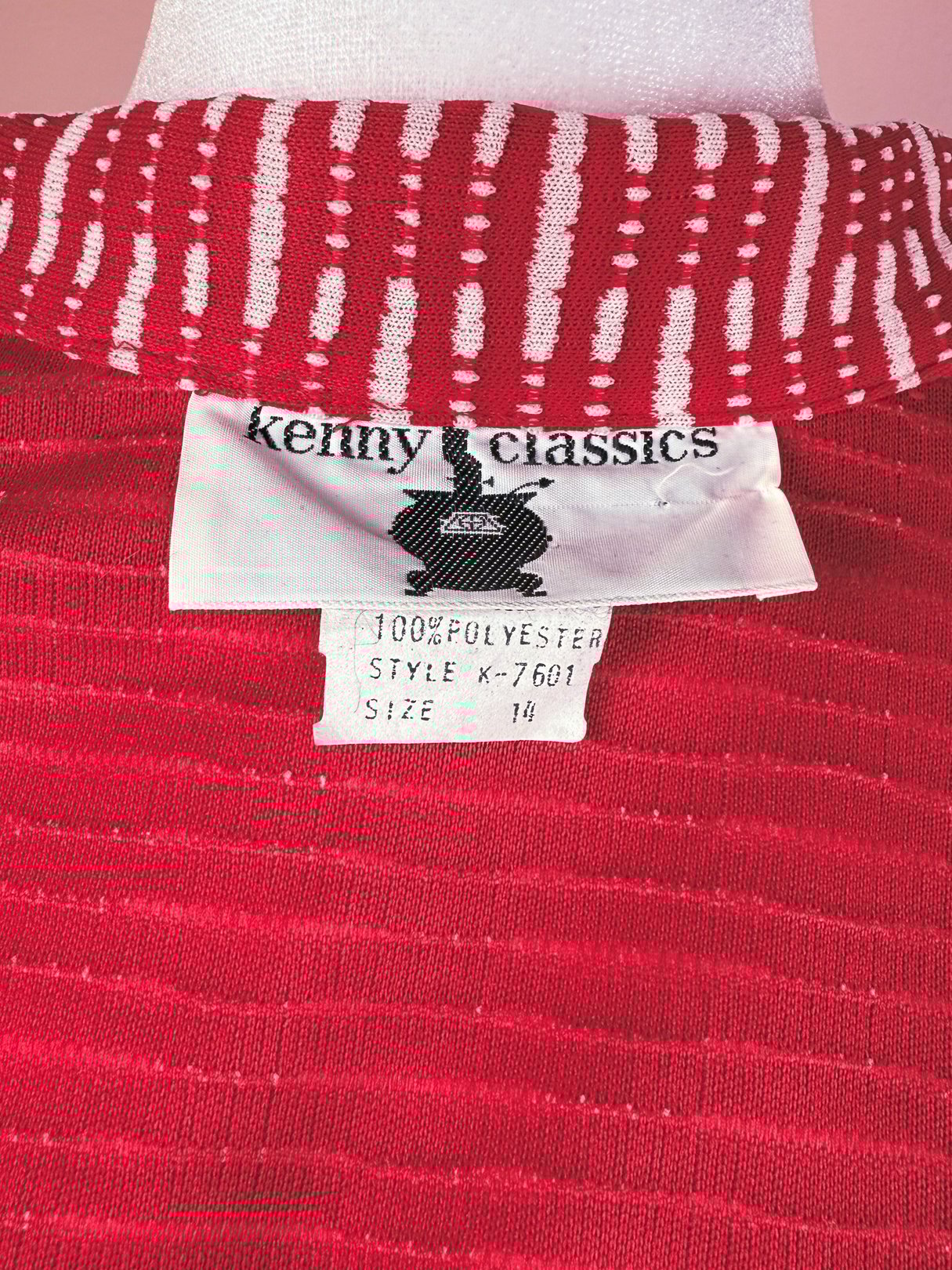 Red knit dress with a striped collar and tag indicating it is a women's size 14 from the 1970s.