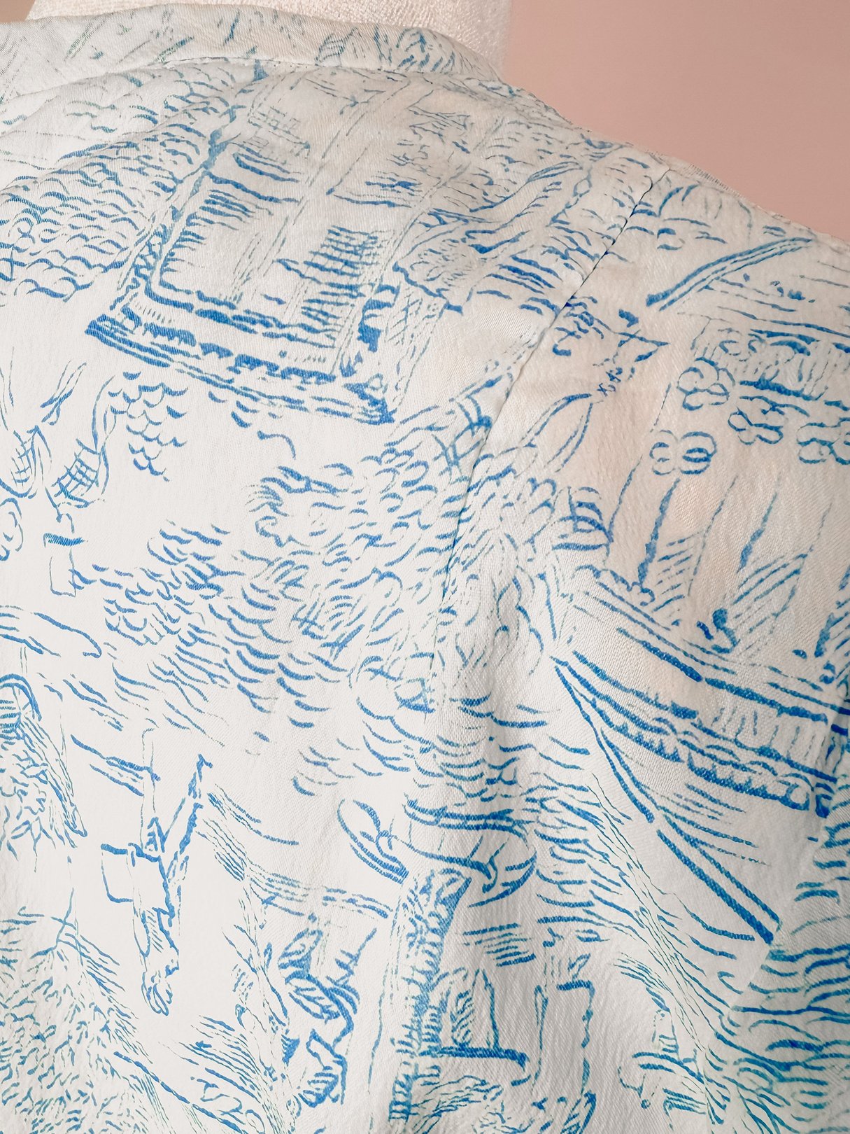 The Paris Montage Dress features a blue pattern depicting scenes of boats and landscapes, typical of 1960s fashion.