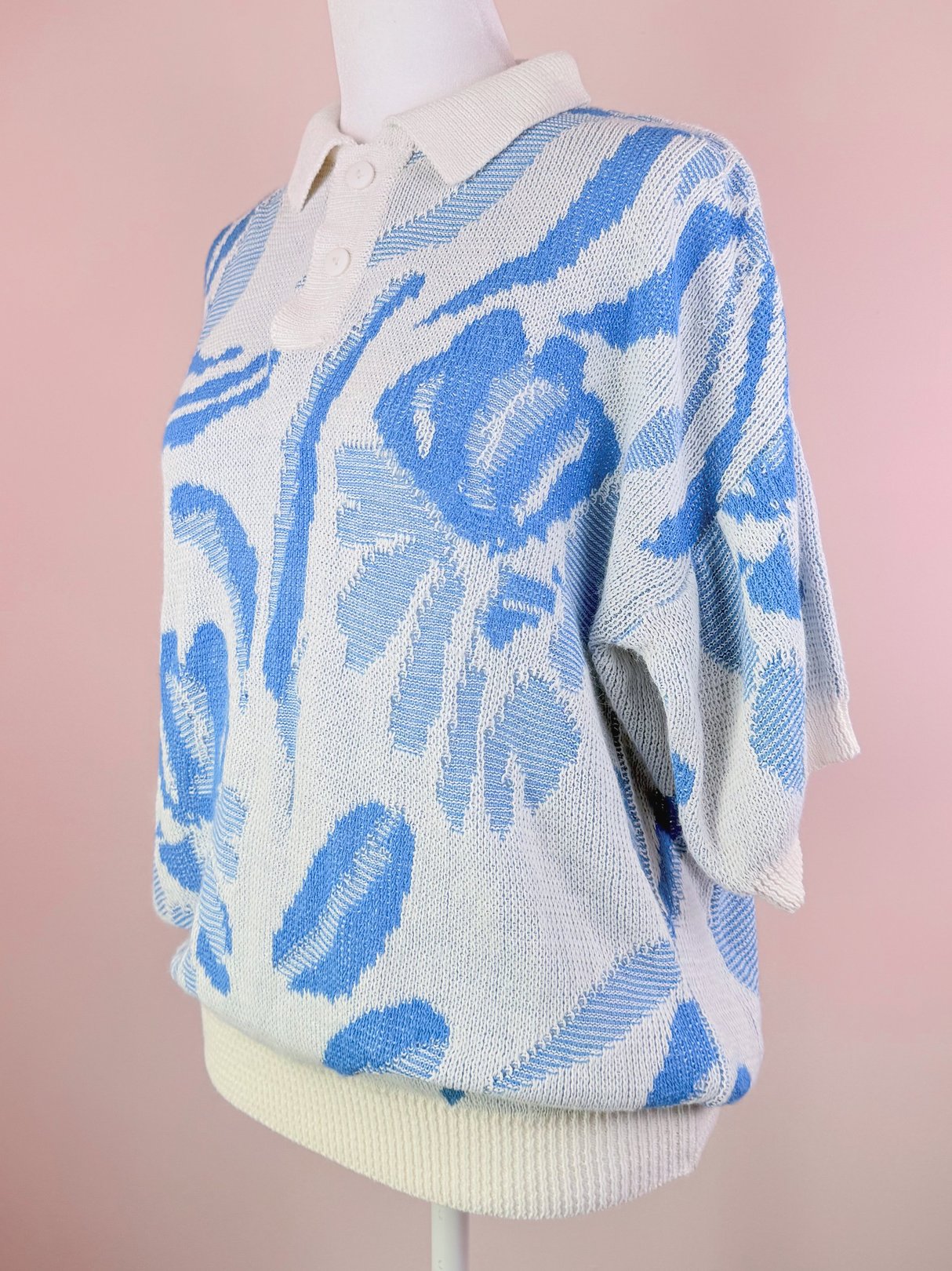 White Yasaki Knit Polo Sweater for women from the 1980s featuring a blue floral pattern and a collared neckline.