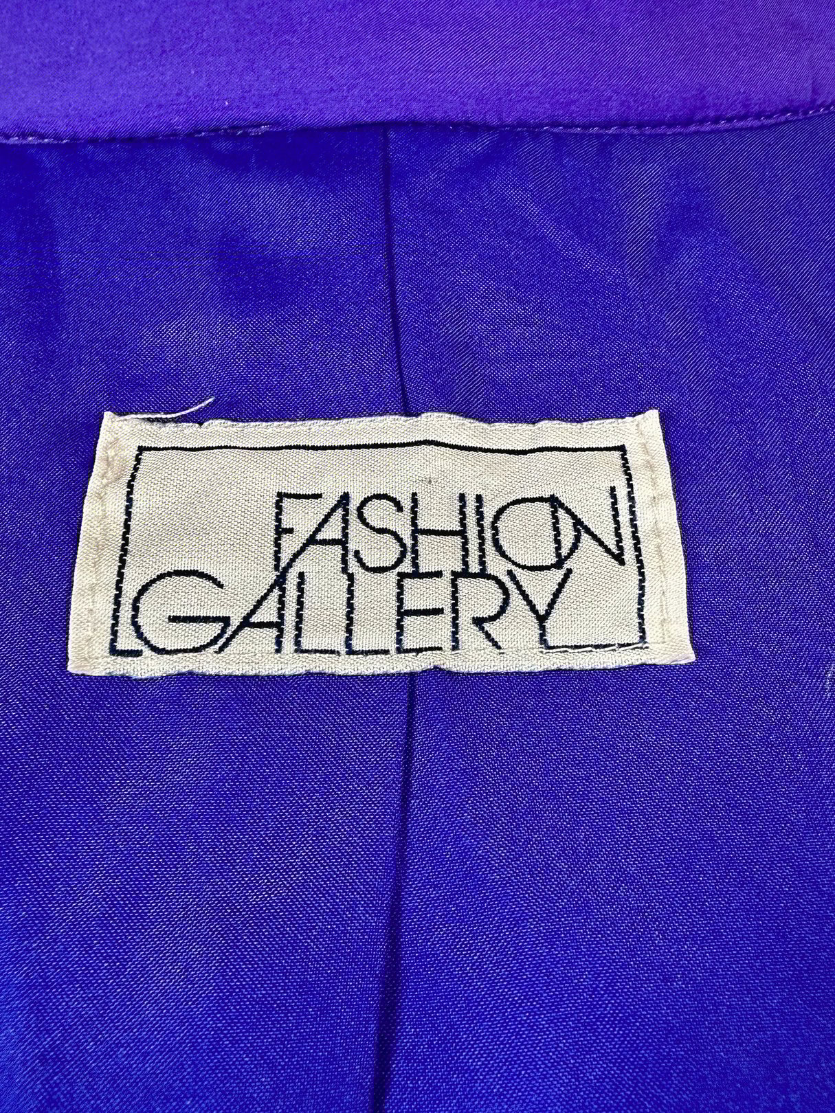 Vibrant violet jacket labeled "Fashion Gallery," featuring 1980s styling for women.