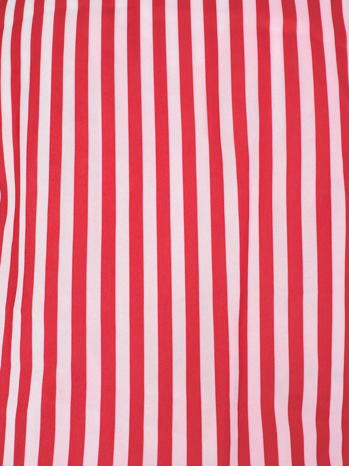 Red and pink striped fabric typical of a women's dress from the 1970s.