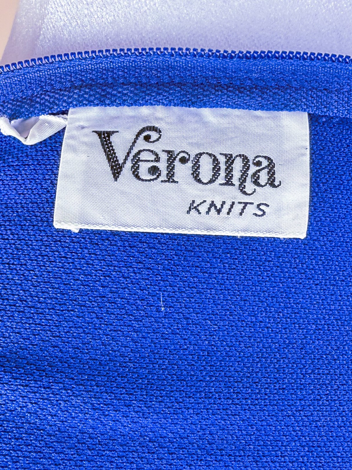 Blue dress label reads "Verona Knits.