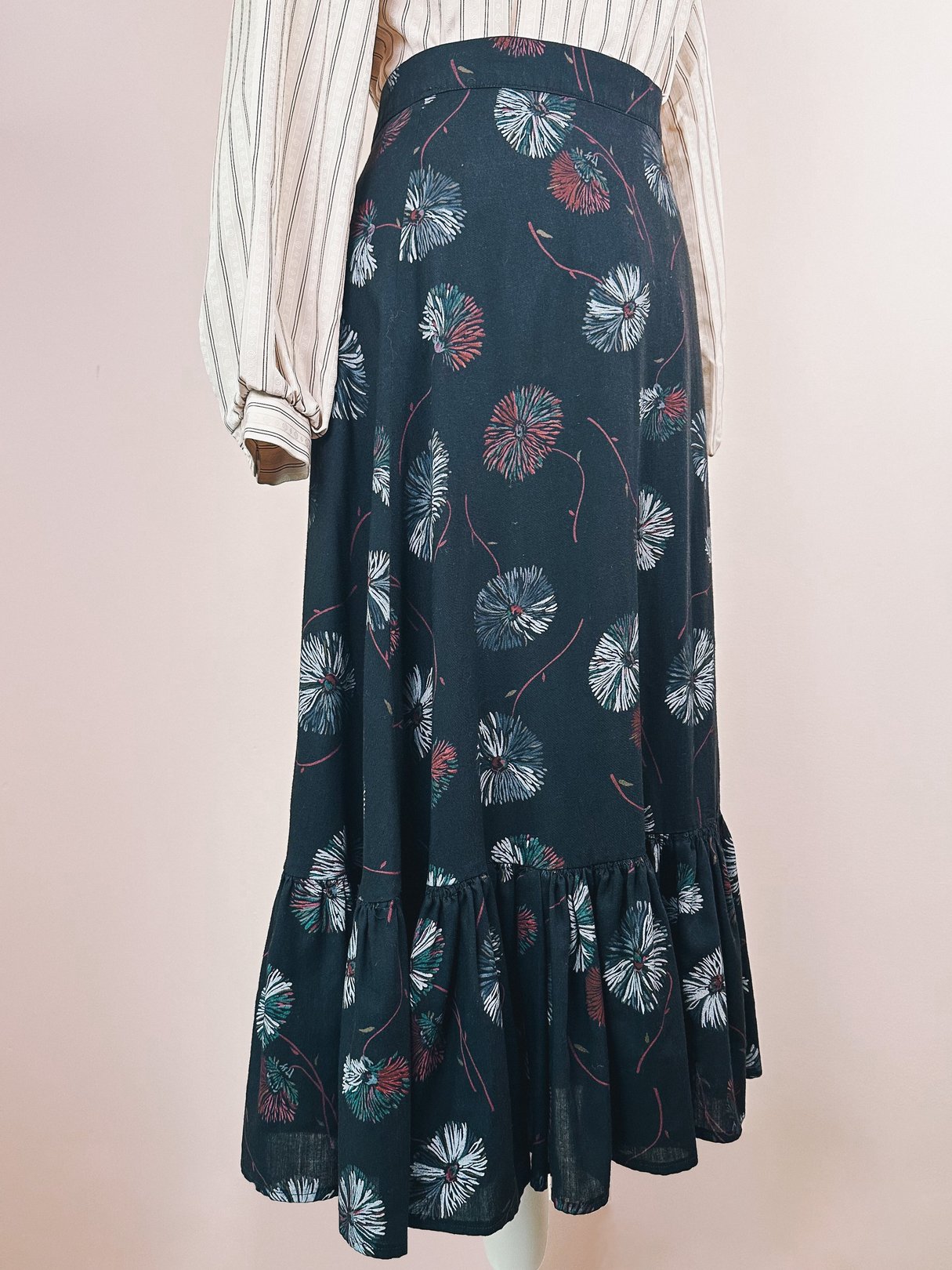 Black 1970s women’s Dandelion Ruffle Skirt with a floral pattern and a flared hem.