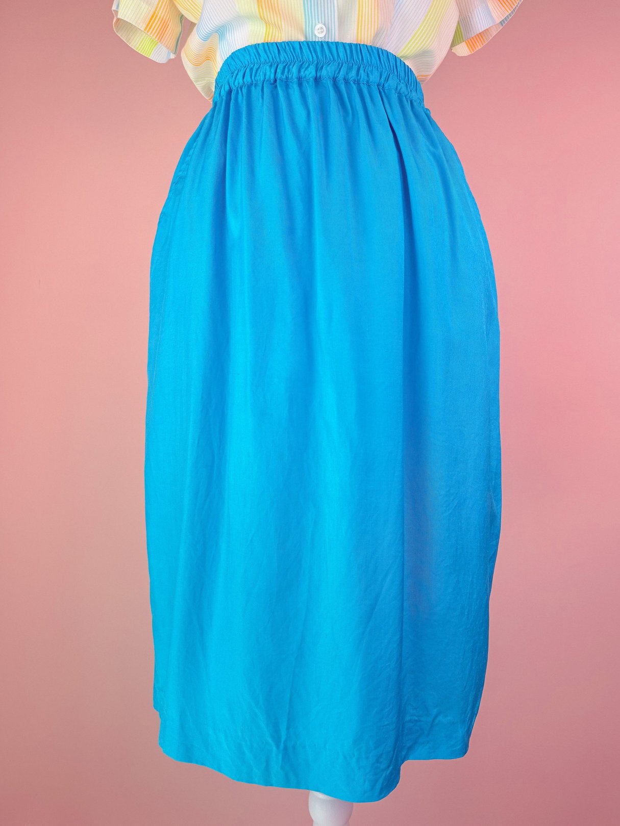 Turquoise blue 1980s women's skirt with an elastic waistband and a flowy silhouette.