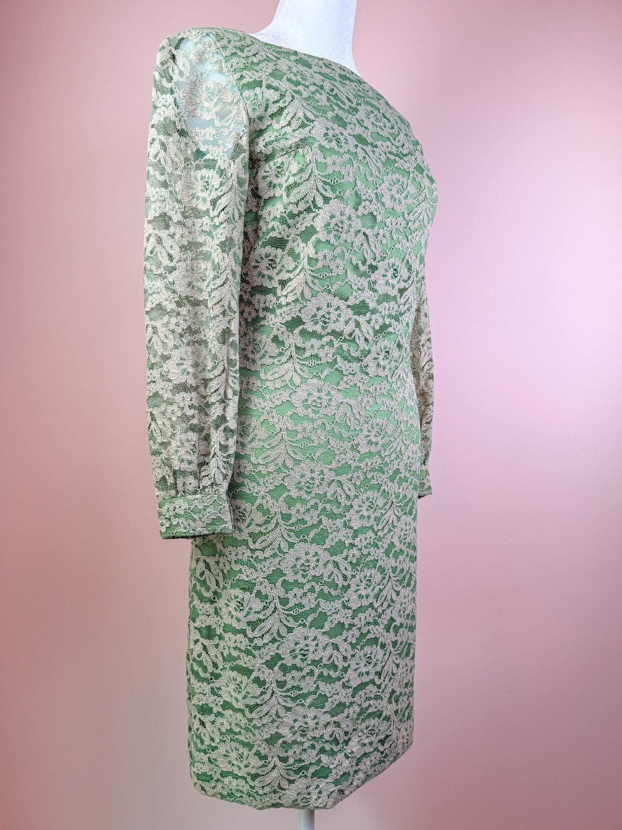 Seafoam green 1960s lace dress with long sleeves and a fitted silhouette.