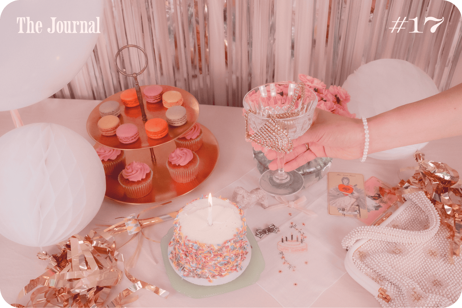 A table is decorated with a colorful cake, cupcakes, drinks, and party accessories, set against a festive backdrop.