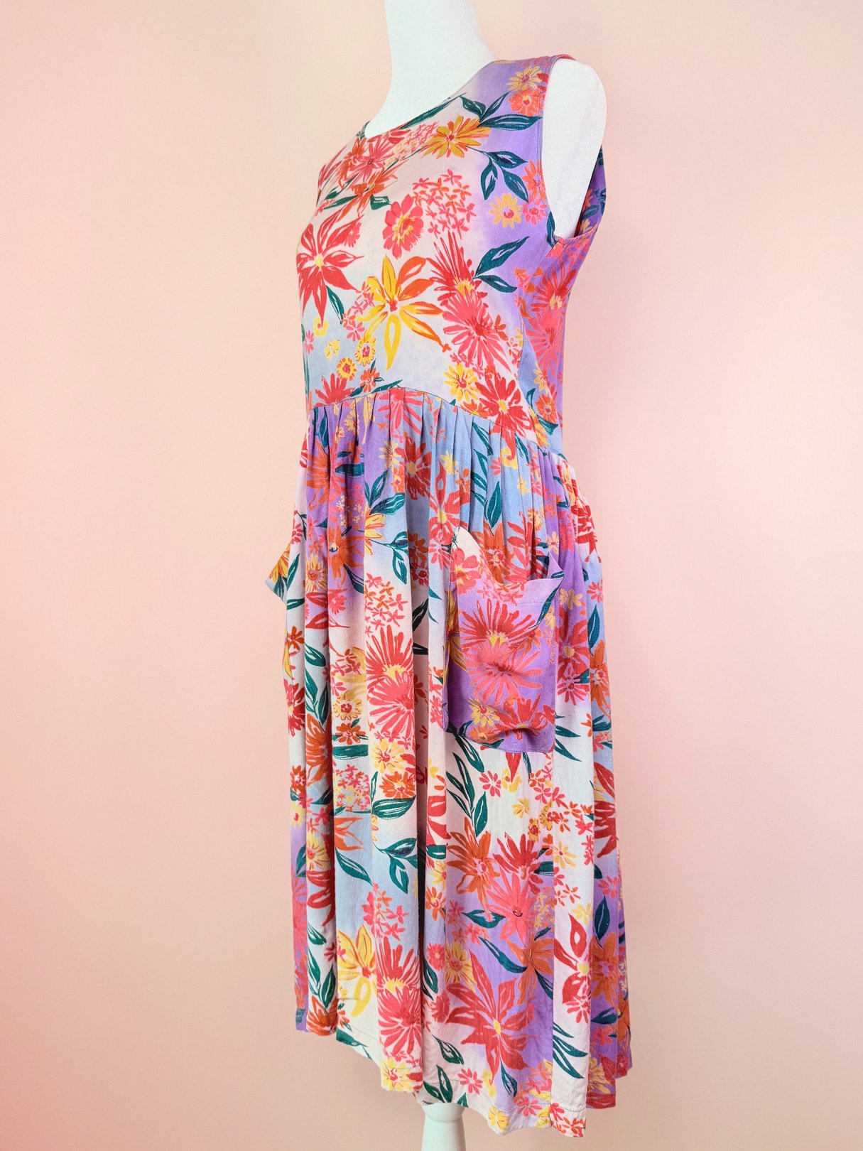 A 1990s women’s Summer Bouquet Dress in pink with a floral print and a pleated skirt.