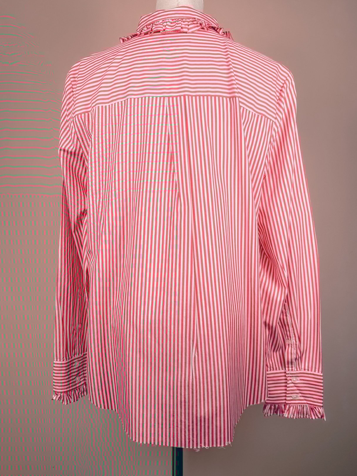 Red and white striped button-down top for women featuring long sleeves and a frilled collar, representing 1970s fashion.