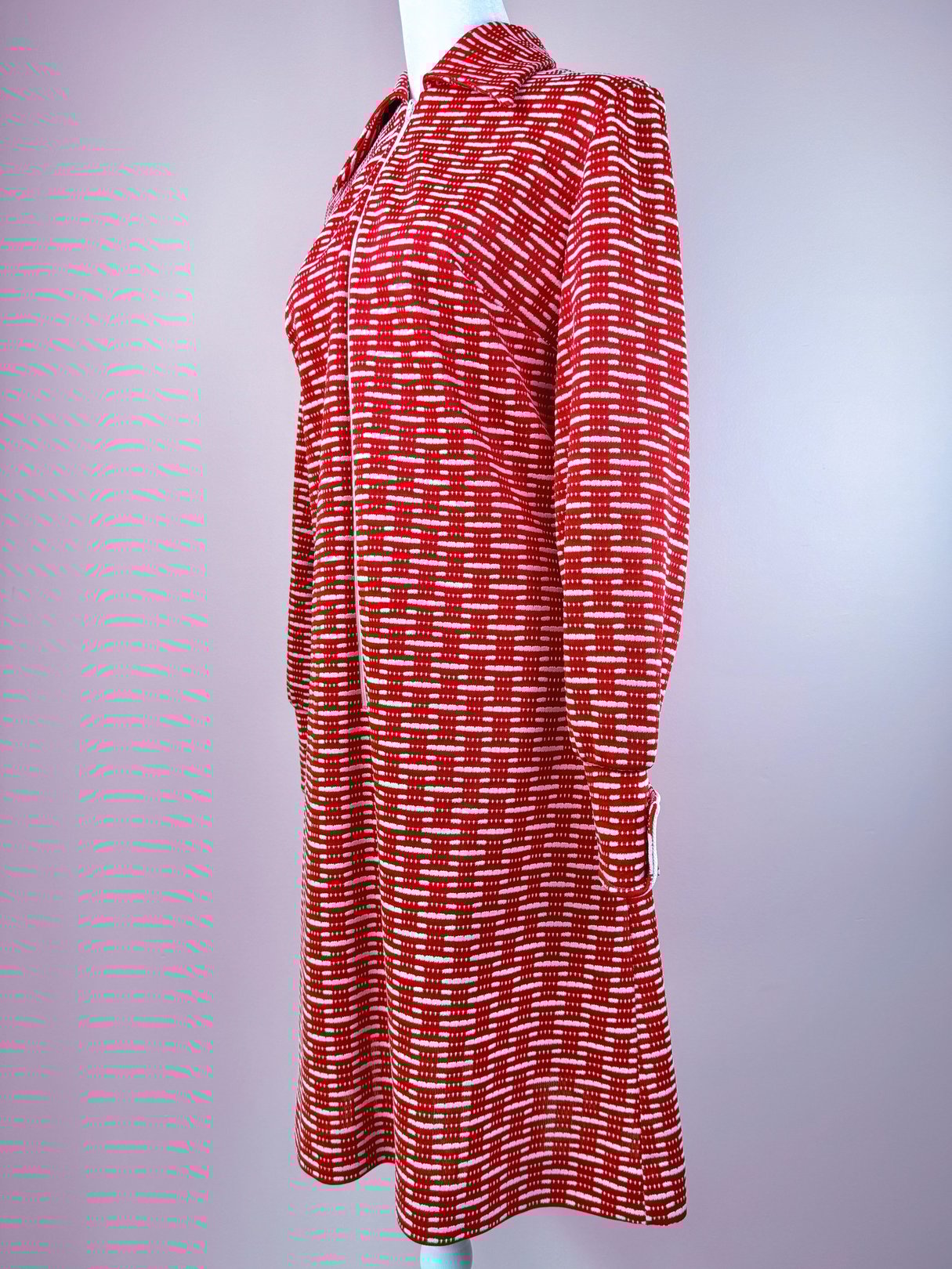 Red 1970s women's knit dress with a textured pattern and long sleeves.