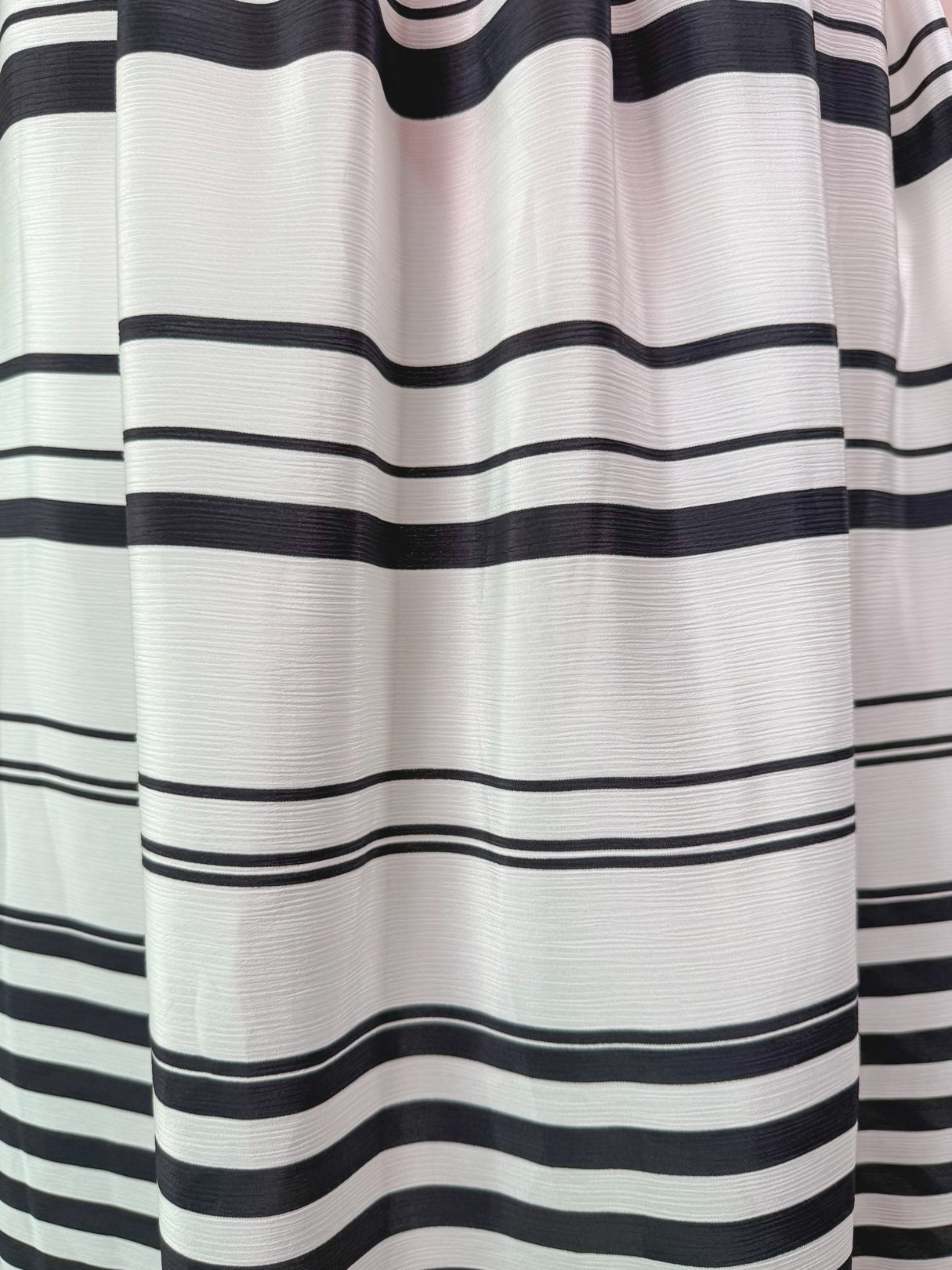 White skirt featuring bold black stripes, characteristic of 1970s fashion.
