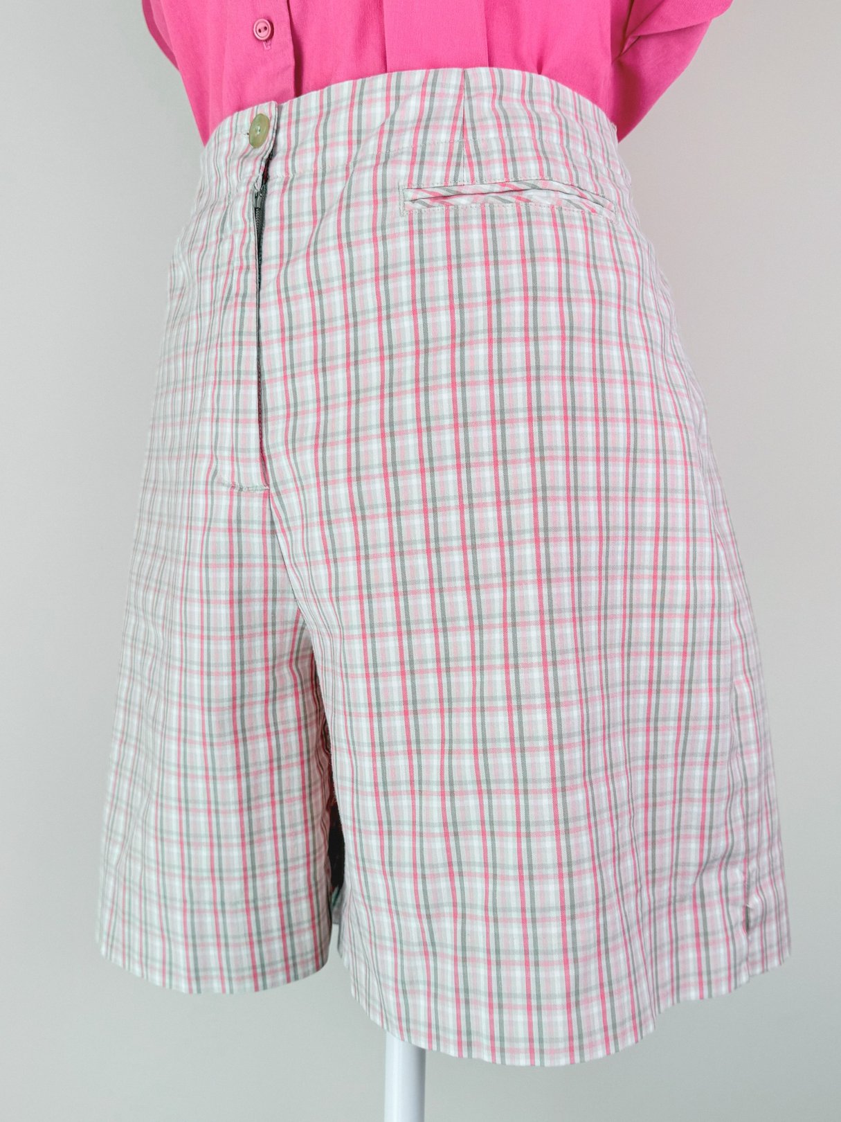 Women’s 1980s pink plaid shorts featuring a high waist and single front pocket.