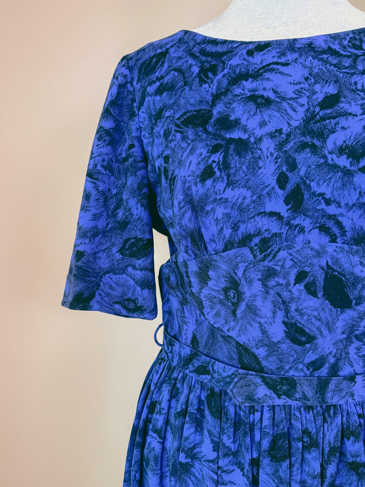 Midnight blue 1960s women's dress featuring short sleeves and a floral pattern.