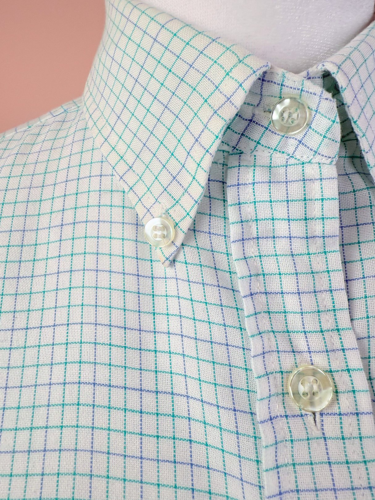 White checkered button down shirt featuring a light green and blue grid pattern, designed for women and reflective of 1980s fashion.
