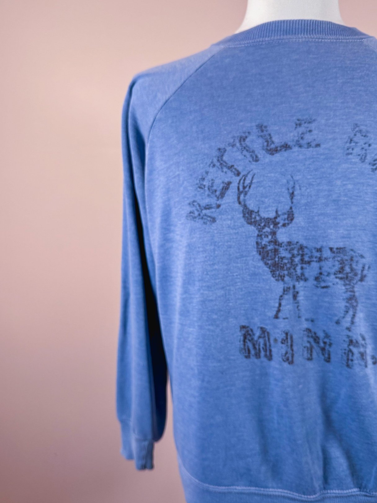 Blue 1970s men’s sweatshirt featuring a graphic print of a deer and the text "Kettle River Minn.