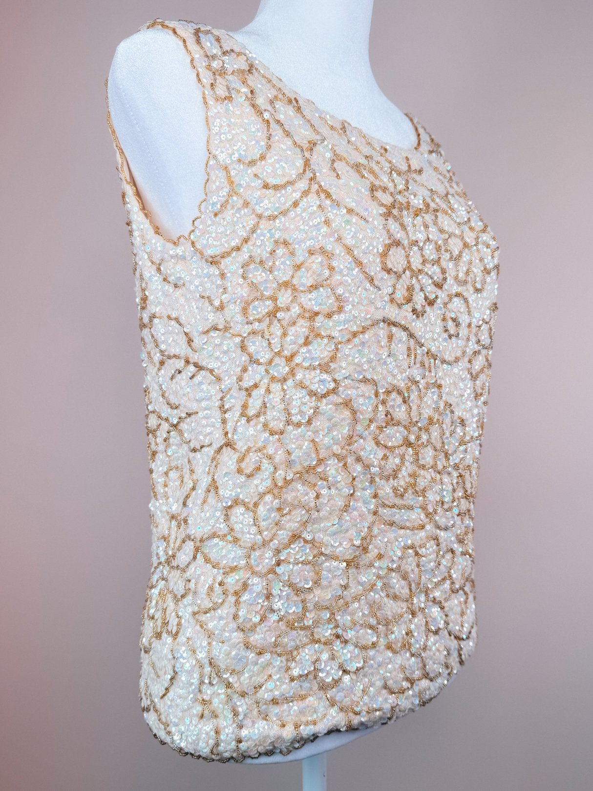 White, beaded top featuring floral patterns and a 1960s design, categorized as a women's sparkle top.