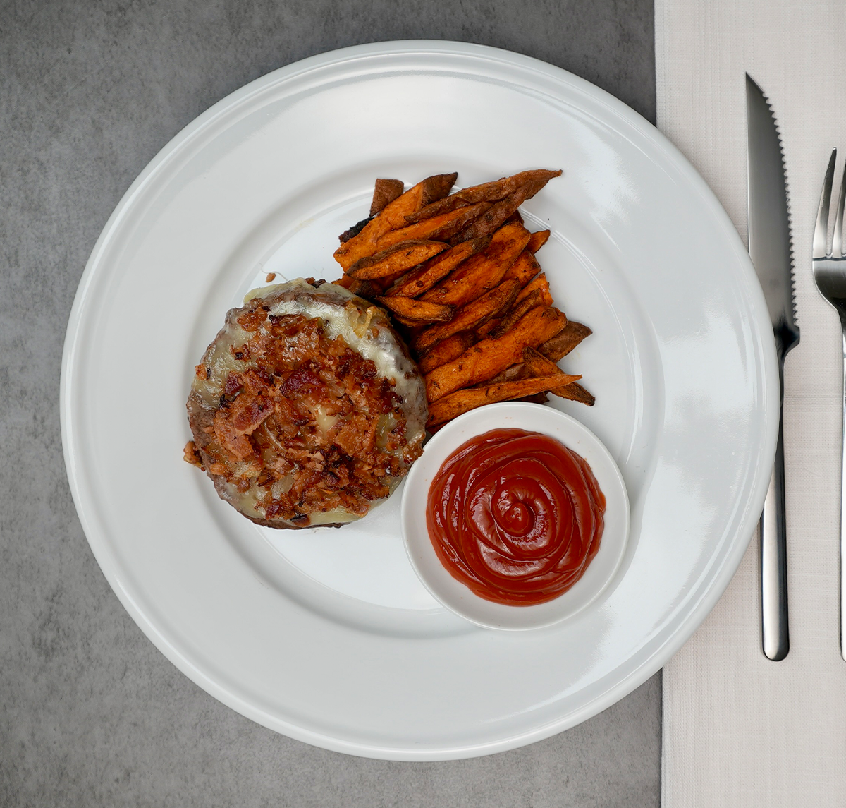 A juicy beef burger topped with melted cheddar and a rich, savory-sweet bacon jam made with Applewood smoked bacon, caramelized onions, and New Eng...