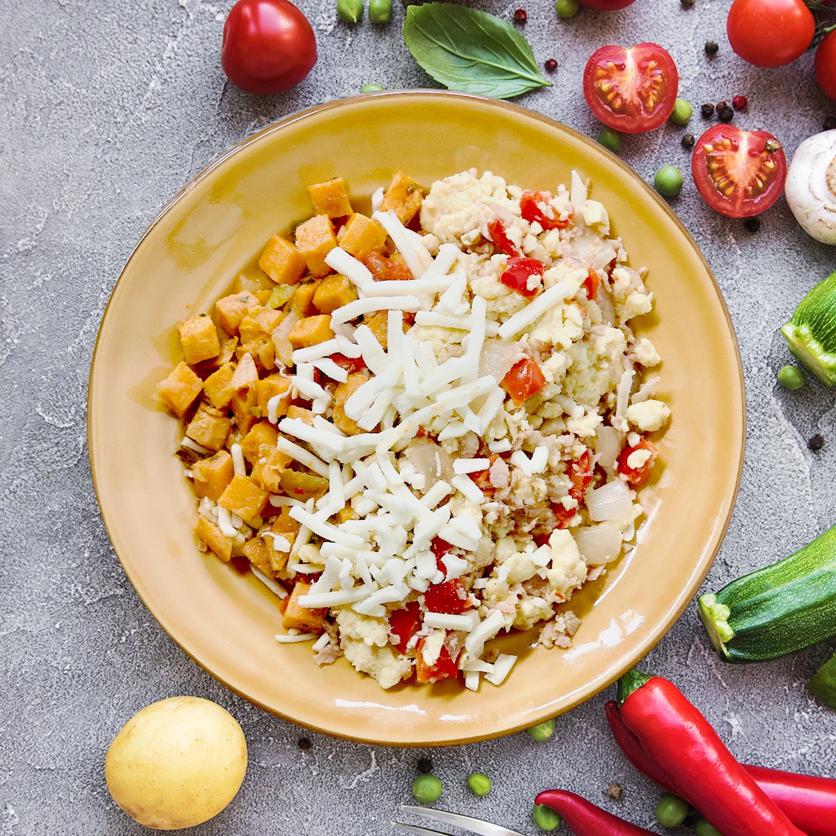 Our egg mix is blended with sliced chicken bacon, peppers, and potatoes before getting cooked on the griddle.