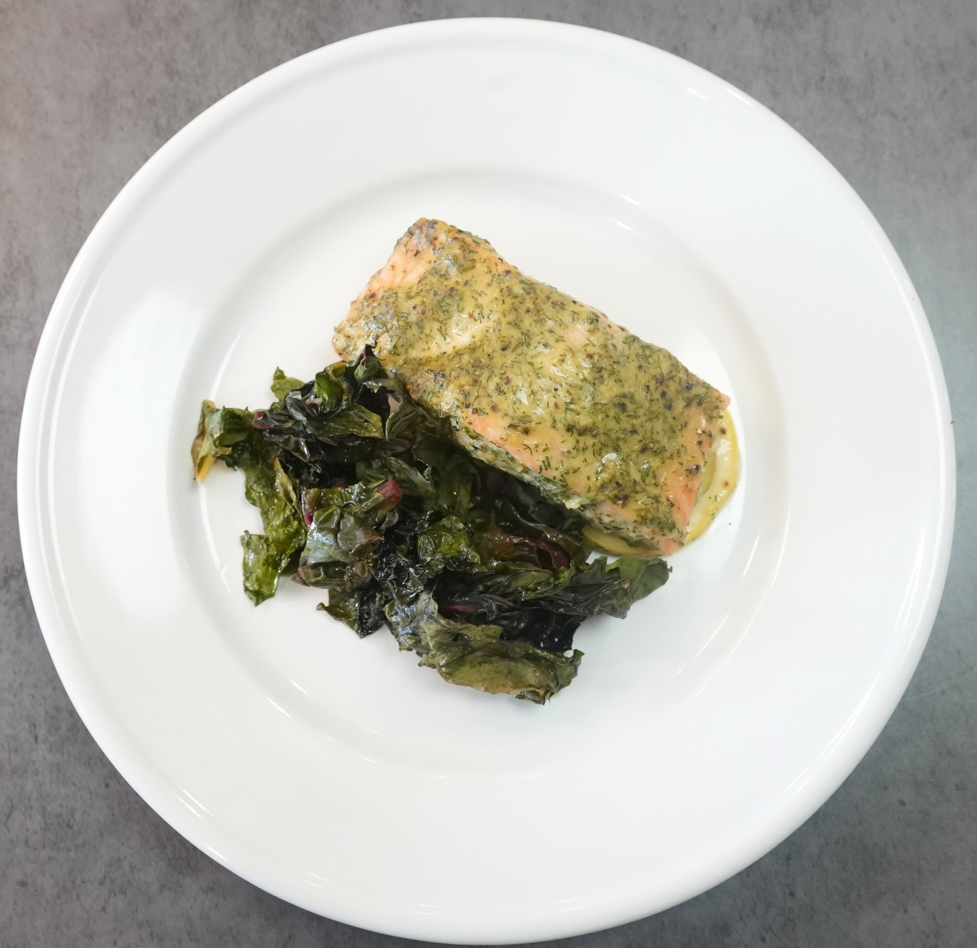 Pan-seared salmon with fresh citrus herb marinade and Mediterranean side