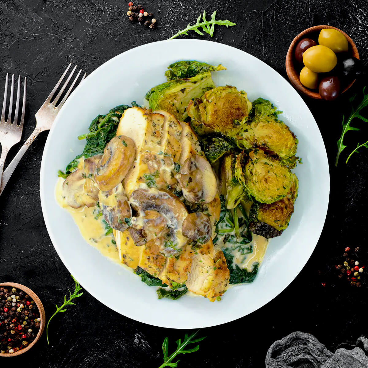 Antibiotic-free chicken breast in a rich mushroom cream sauce with spinach and Parmesan